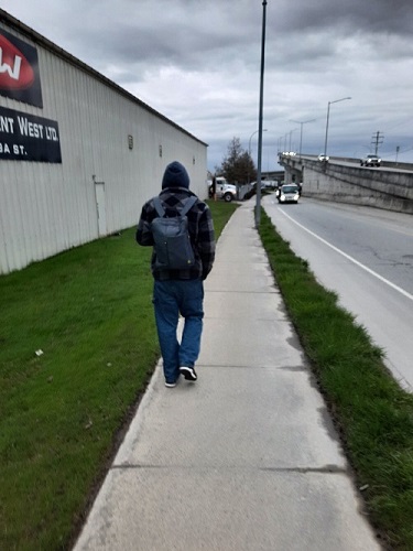 Picture of a man's back as he is walking away