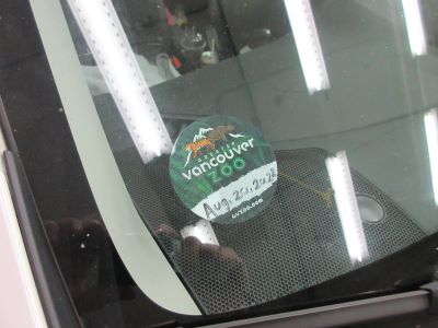 Vancouver Zoo sticker in front windown of Naomi's vehicle